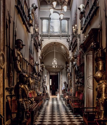 a hallway with armor and armor on the walls