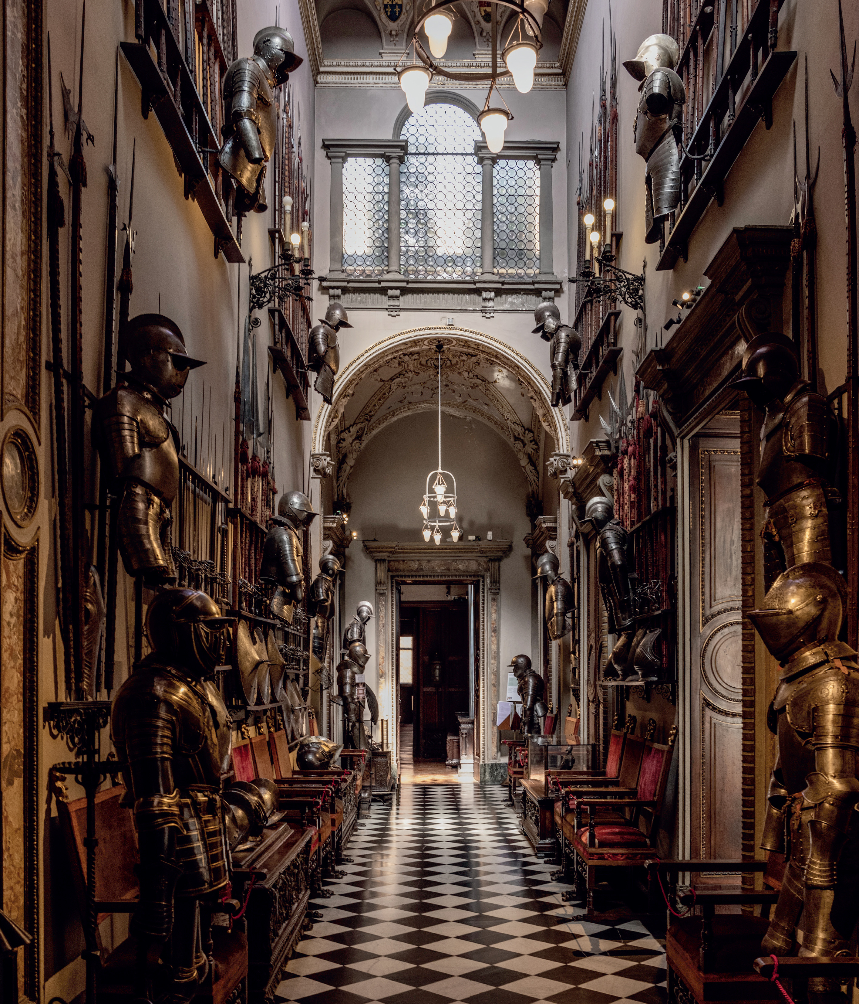 a hallway with armor and armor on the walls