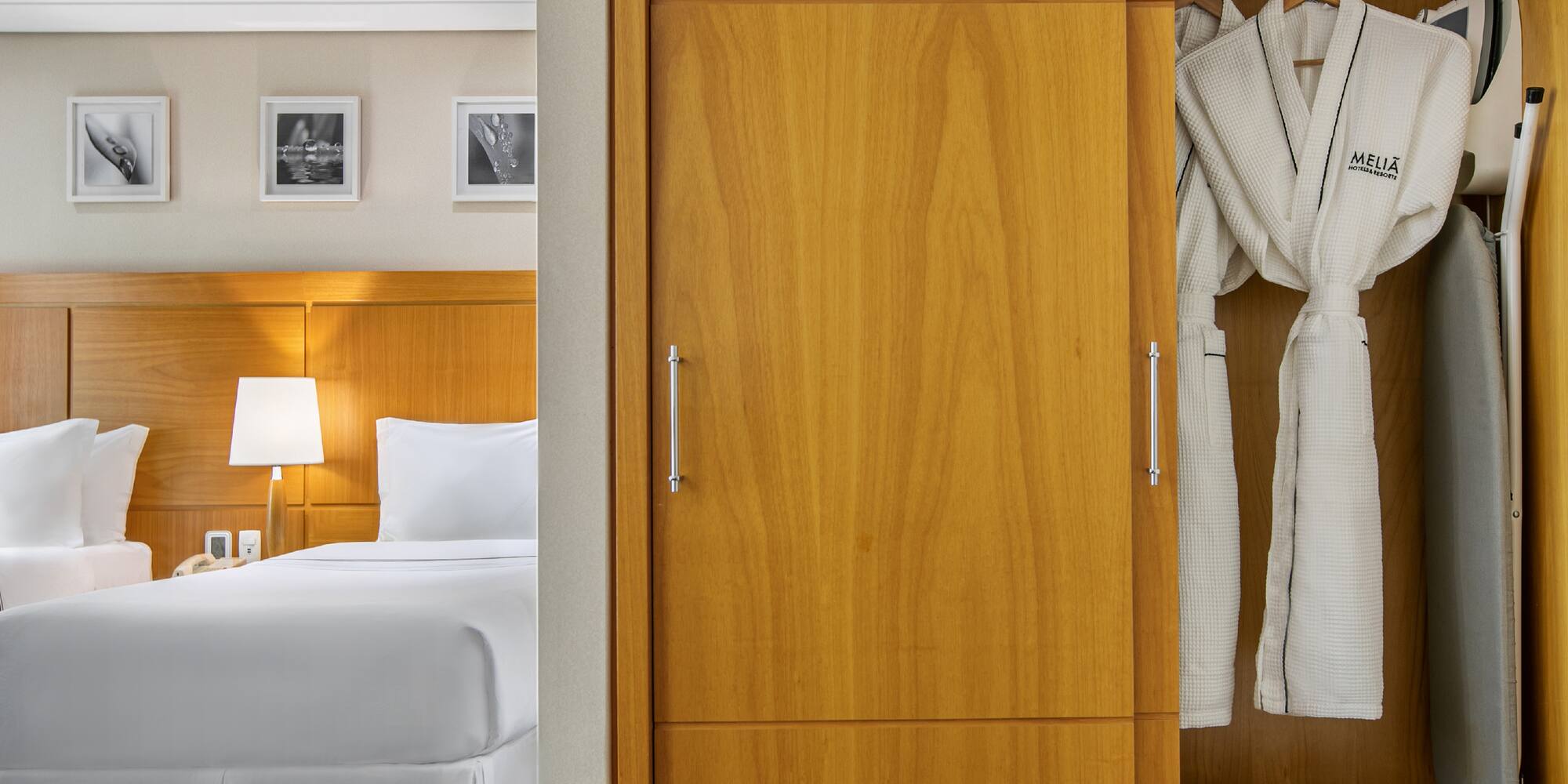 a closet with white bathrobes and a bed