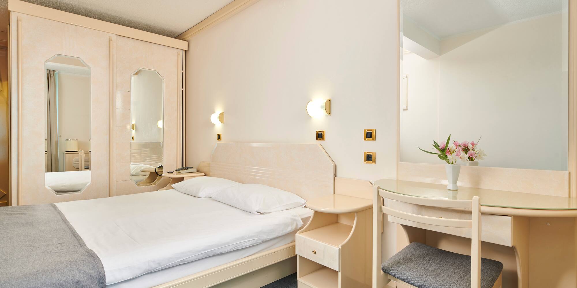 a bedroom with a bed and a mirror