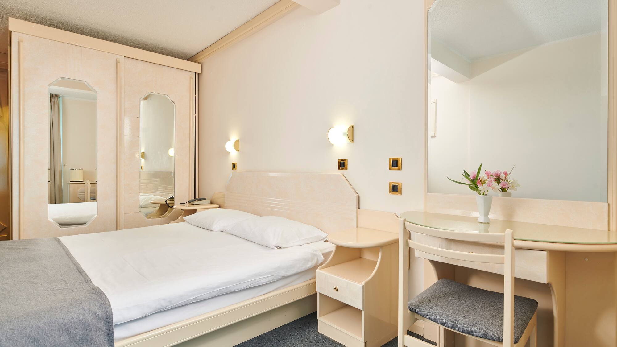 a bedroom with a bed and a mirror