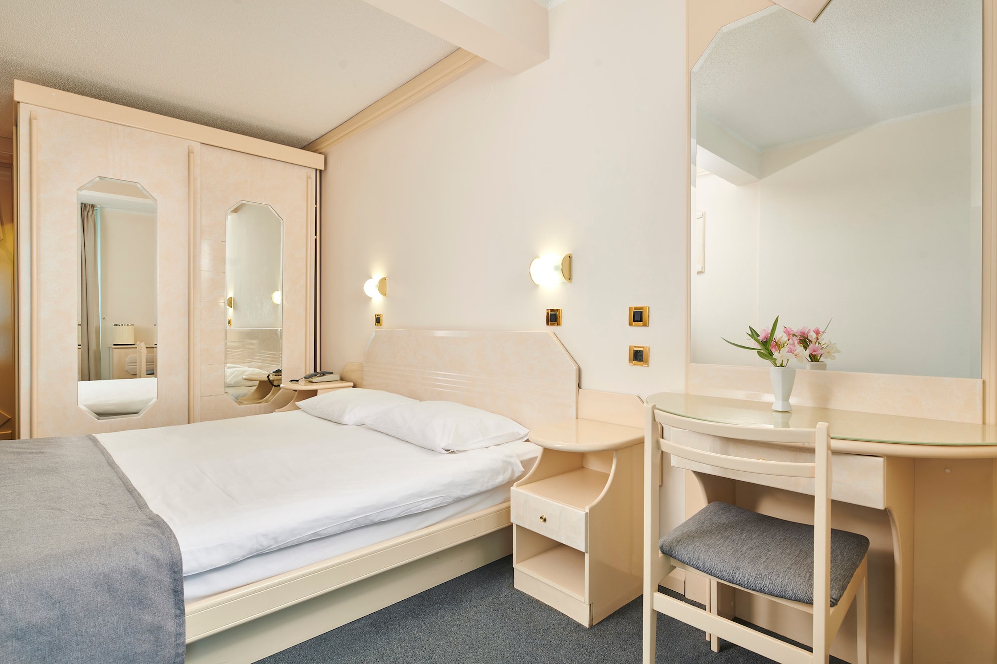 a bedroom with a bed and a mirror