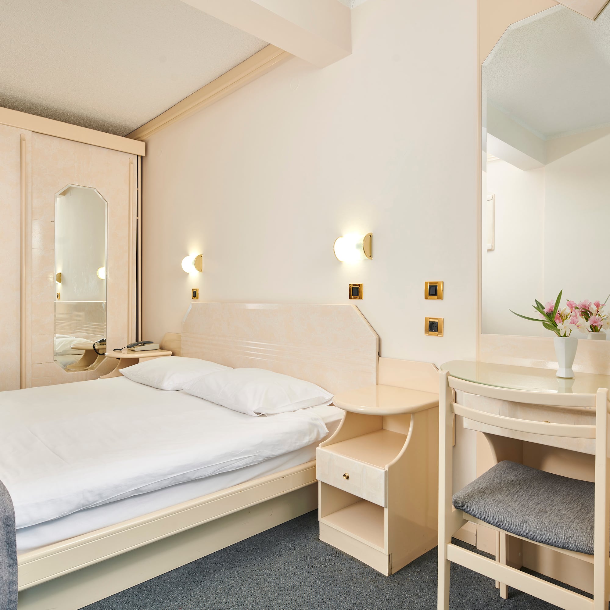 a bedroom with a bed and a mirror