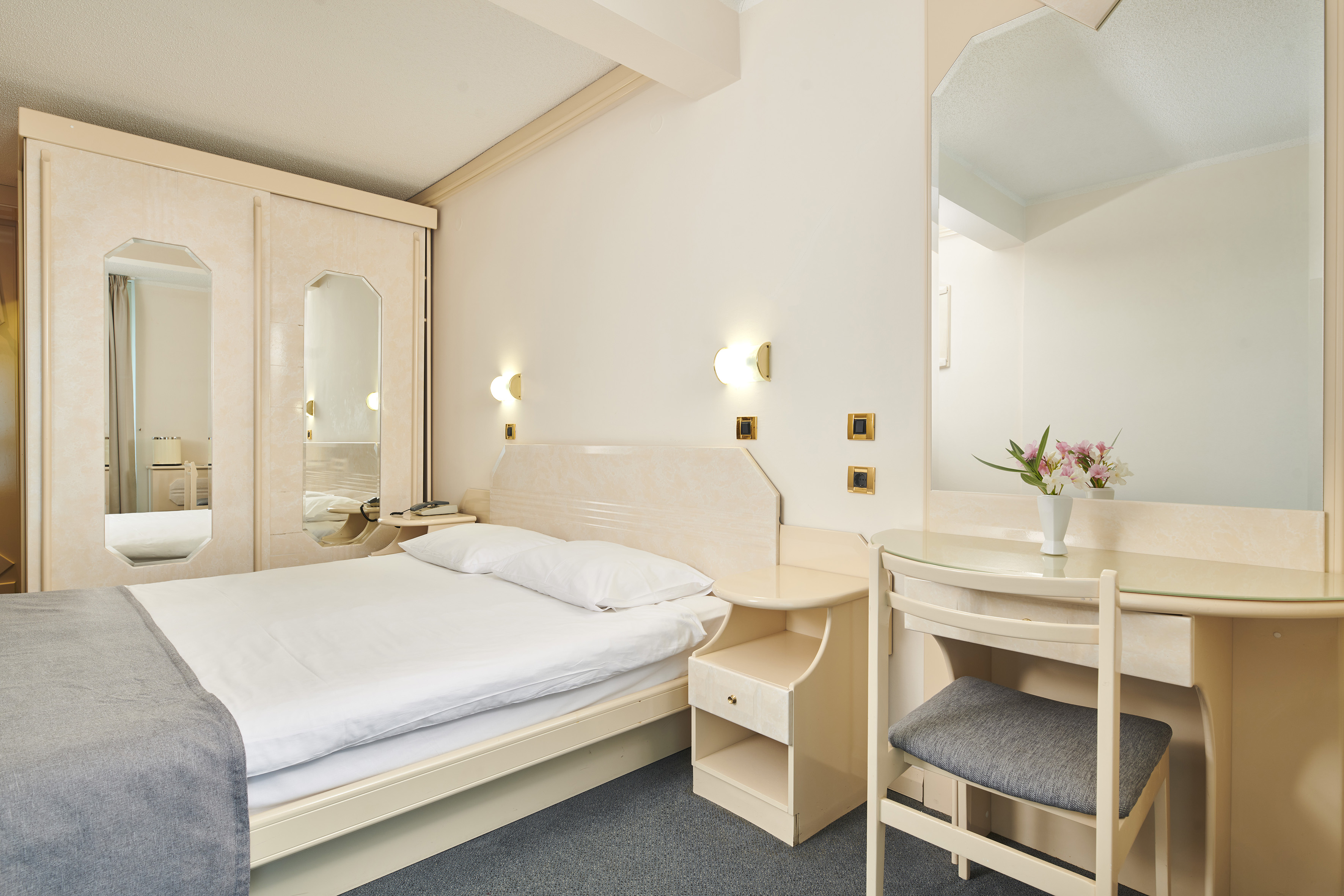 a bedroom with a bed and a mirror