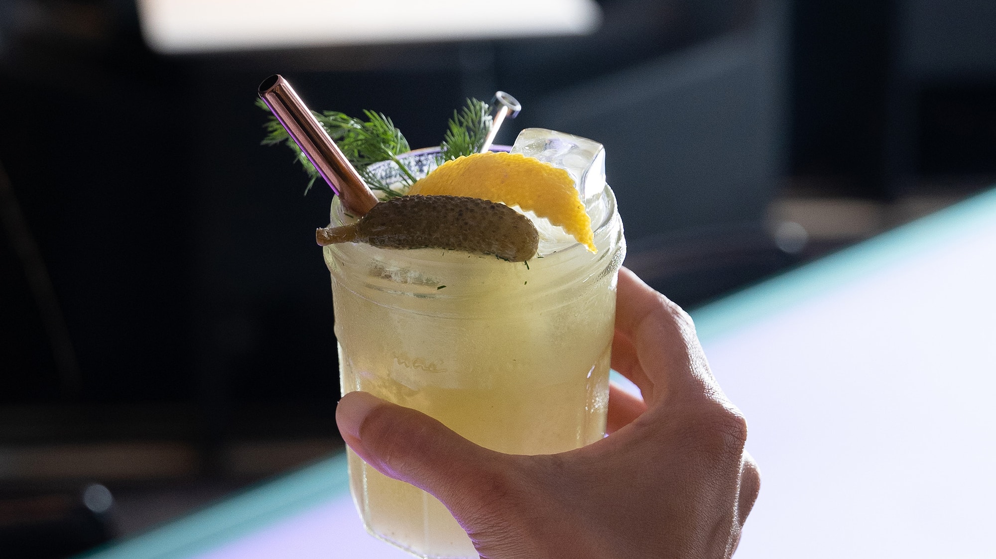 a hand holding a drink