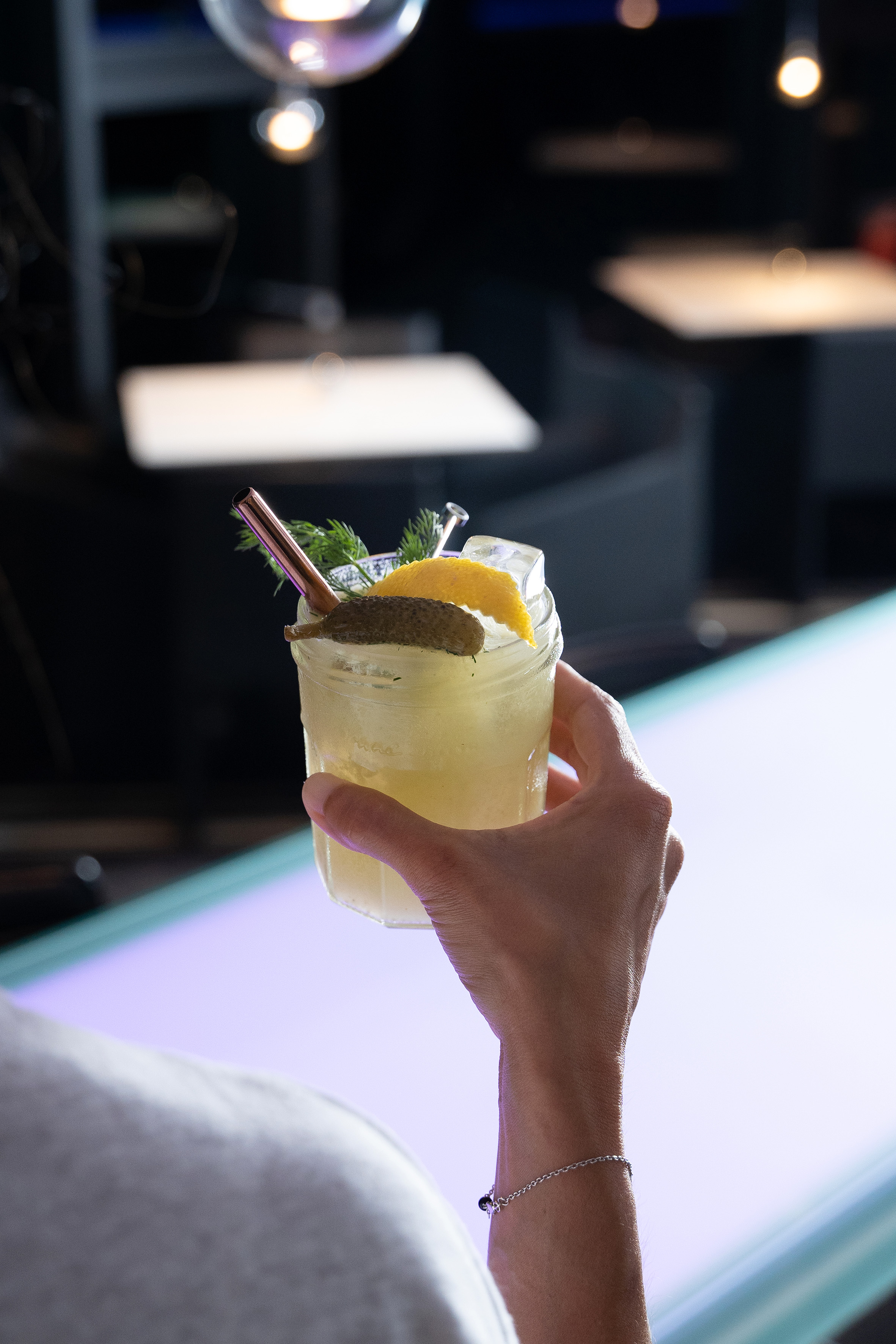 a hand holding a drink