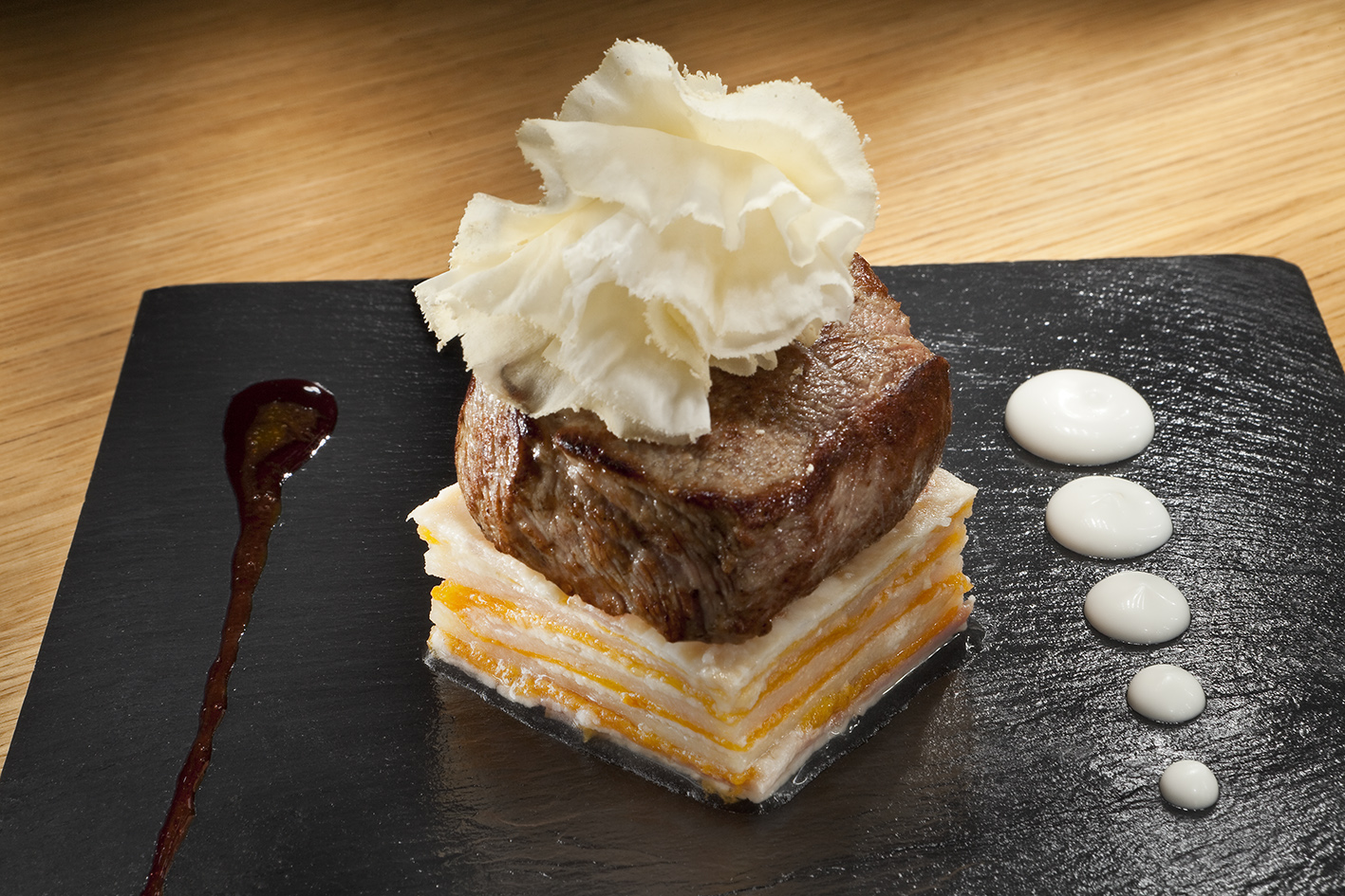 a piece of meat with cheese and sauce on top