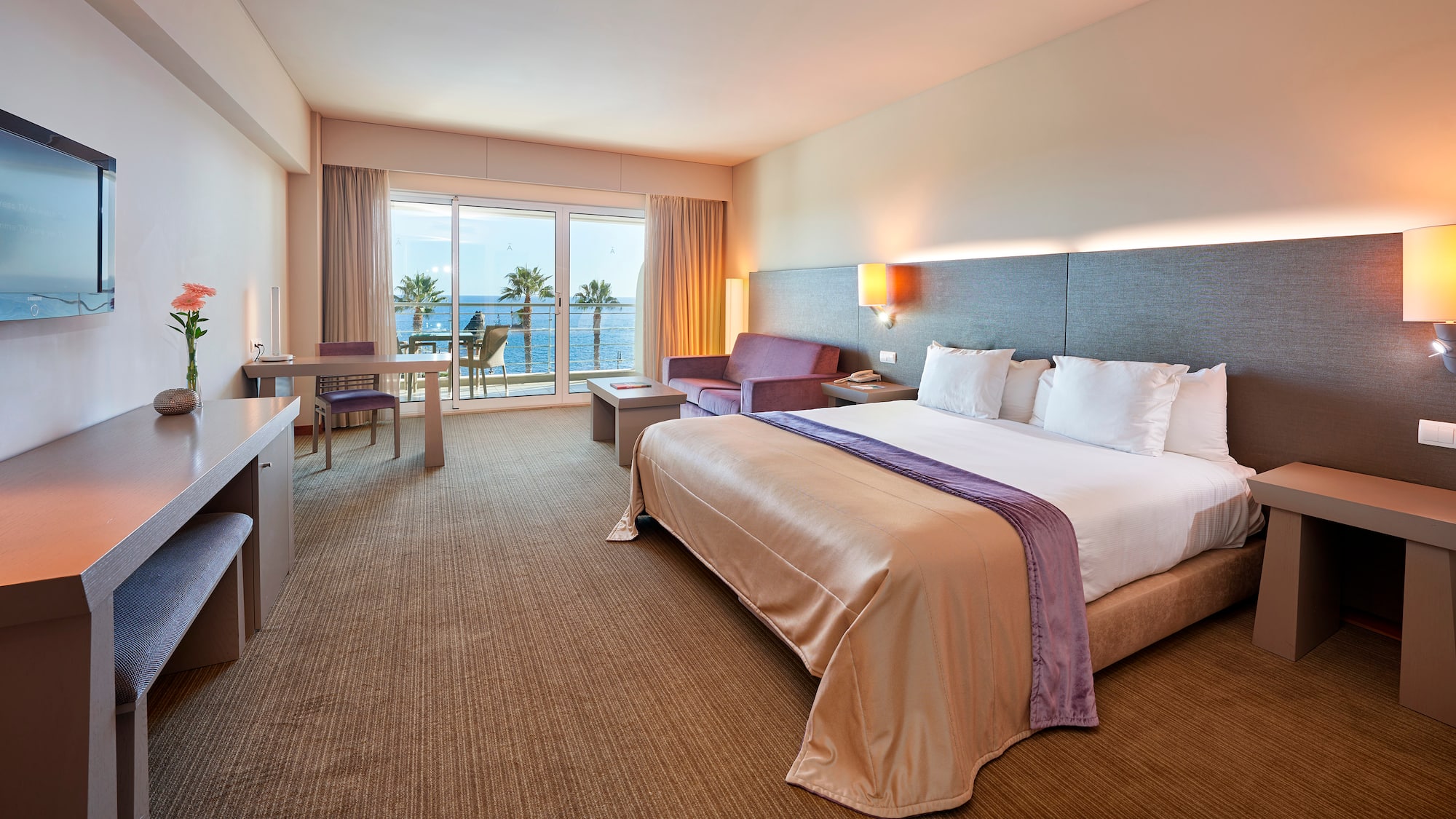 a hotel room with a bed and a television