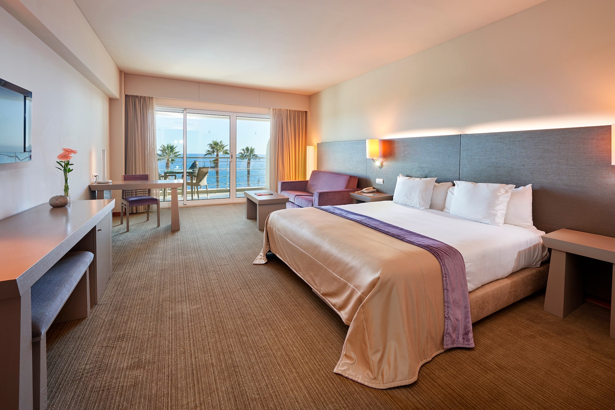 a hotel room with a bed and a television