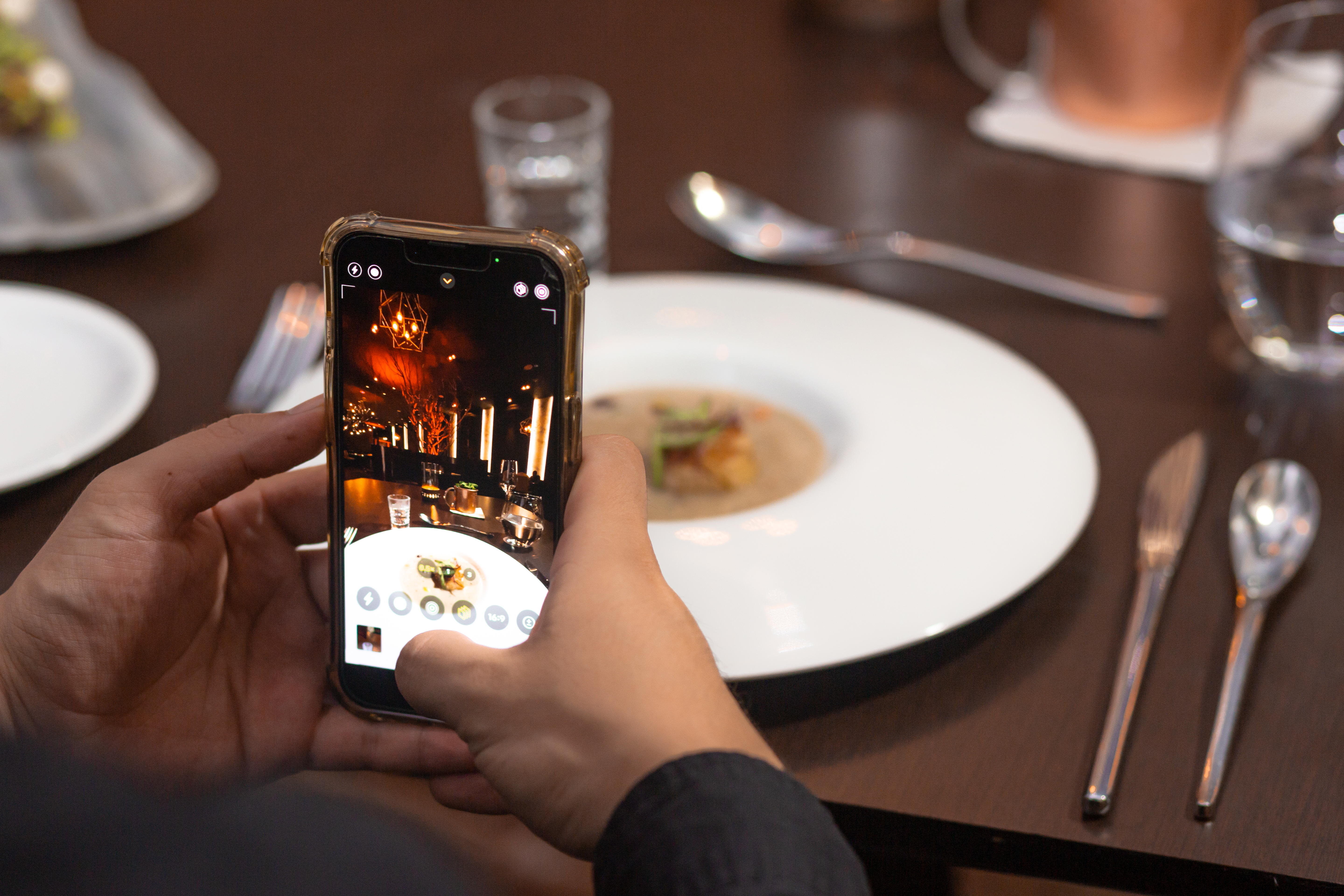 a person taking a picture of food on a plate