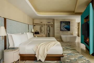 a room with a bed and bathtub