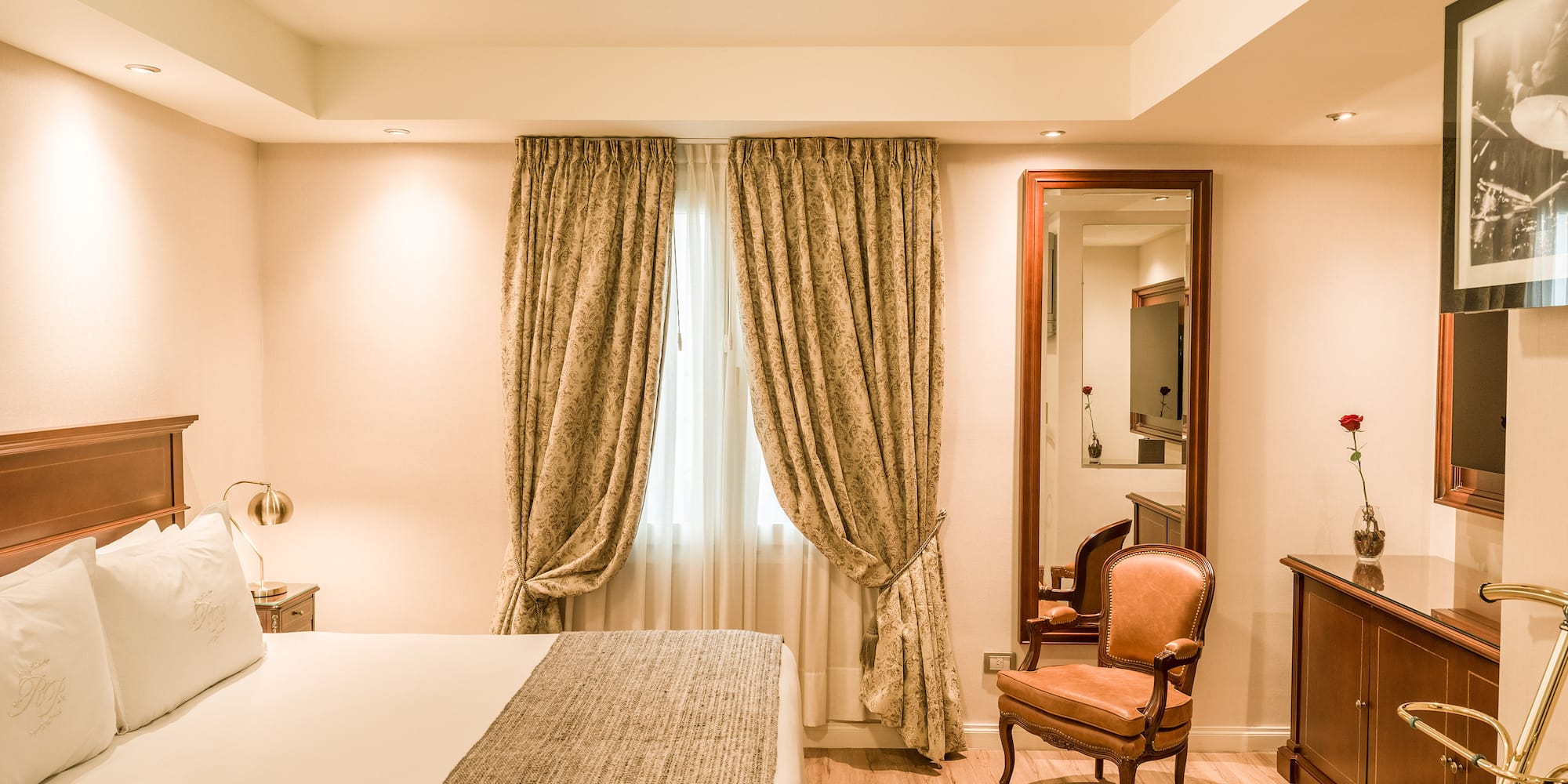 a bedroom with a bed and a mirror