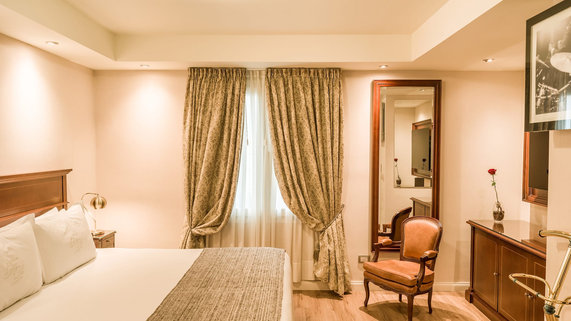 a bedroom with a bed and a mirror