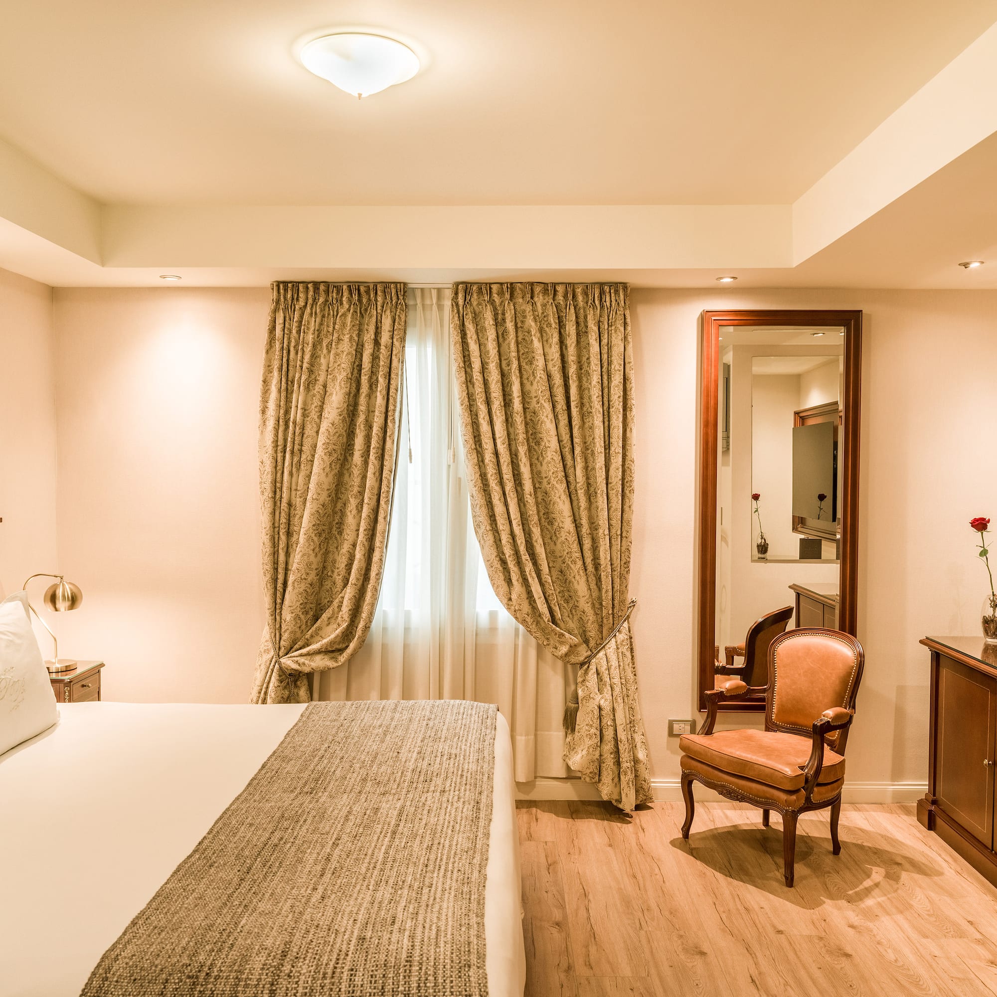 a bedroom with a bed and a mirror