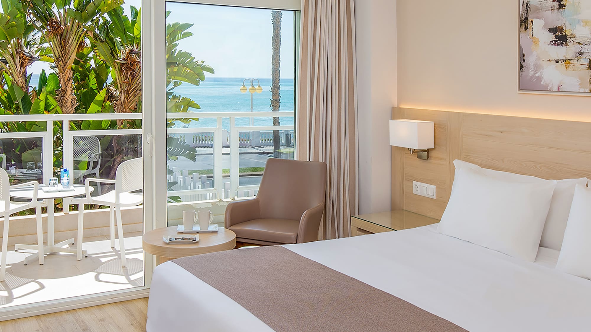 a bedroom with a large bed and a glass door