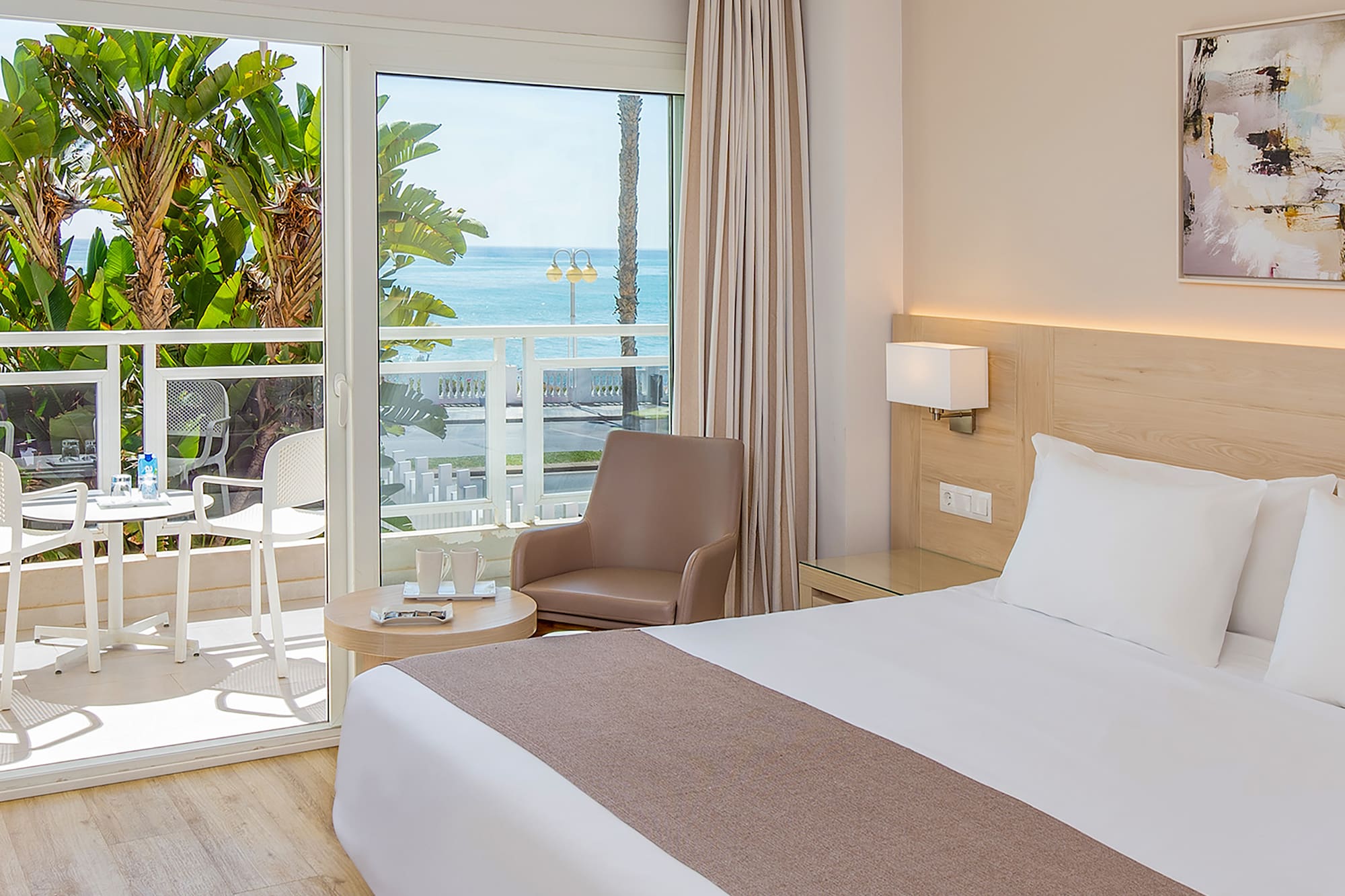 a bedroom with a large bed and a glass door