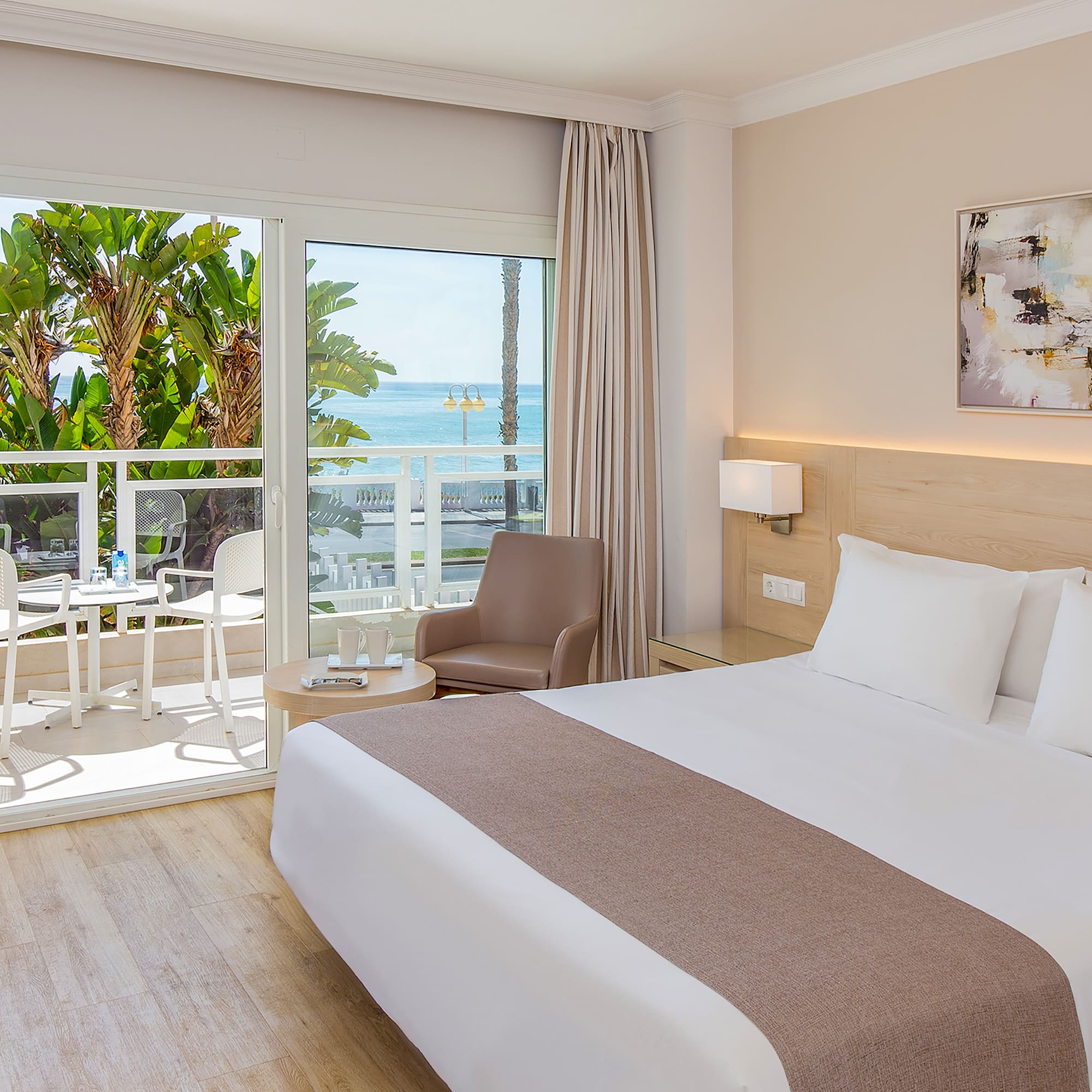 a bedroom with a large bed and a glass door