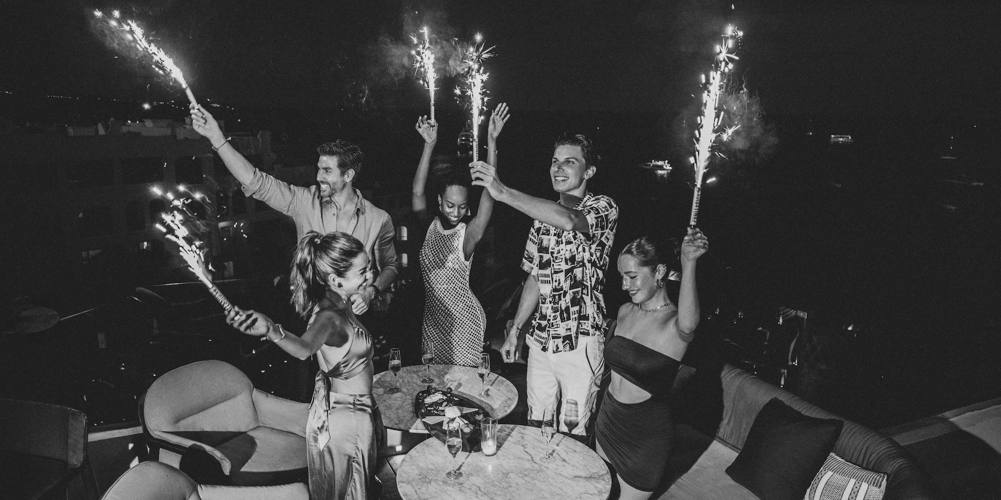 a group of people holding sparklers