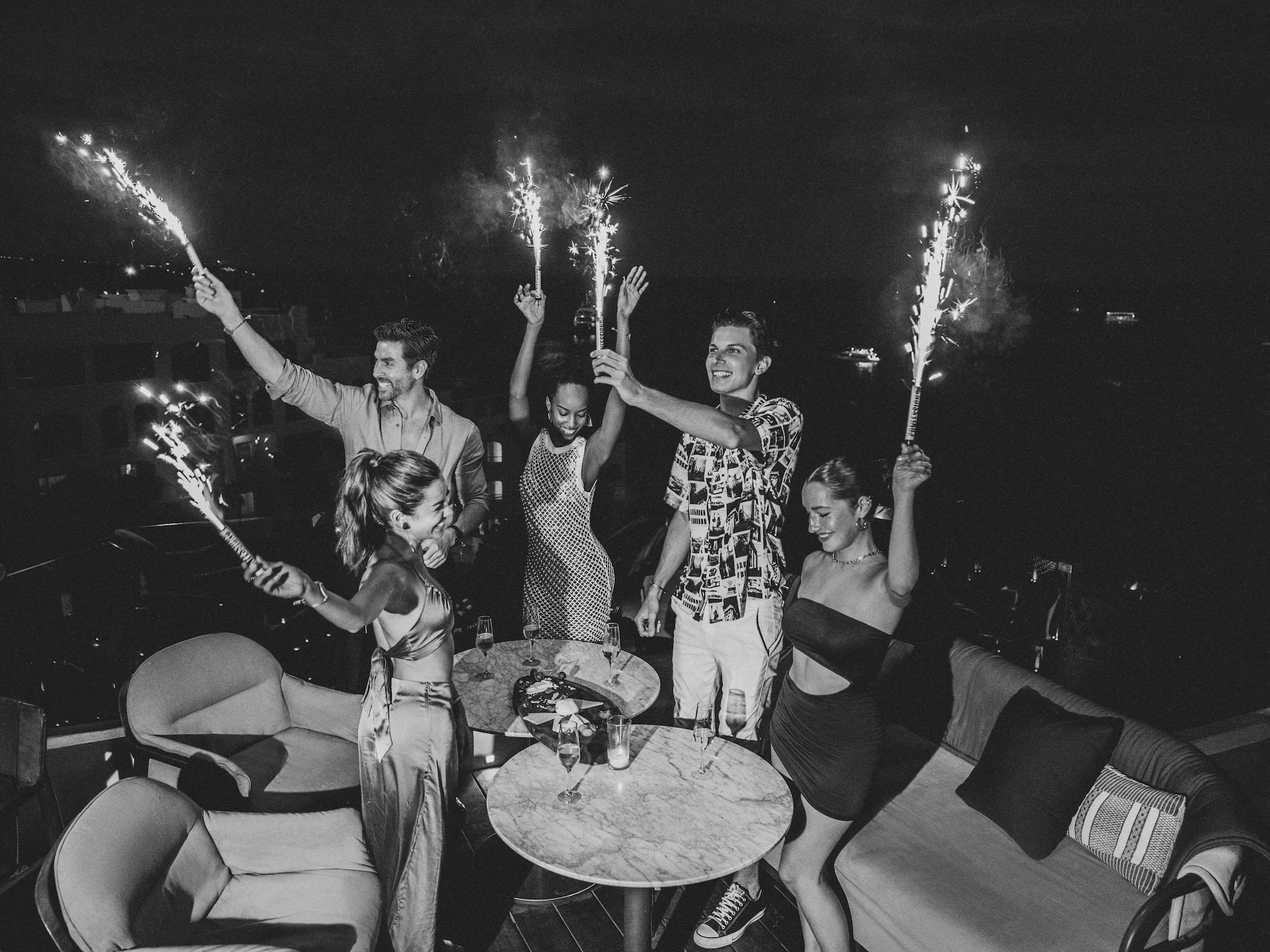 a group of people holding sparklers