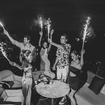 a group of people holding sparklers