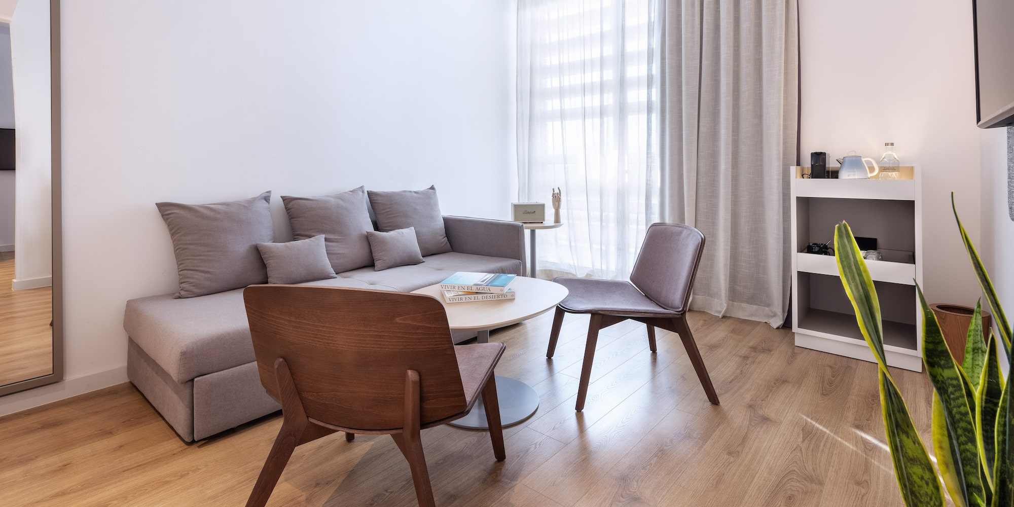 a living room with a couch and chairs