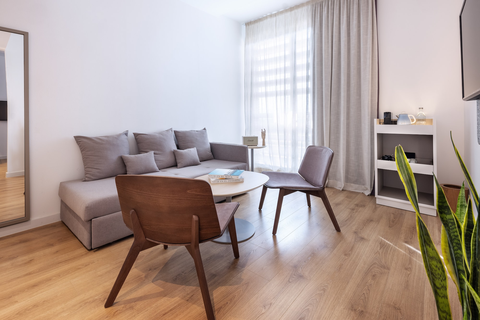 a living room with a couch and chairs