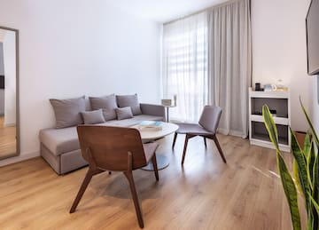 a living room with a couch and chairs