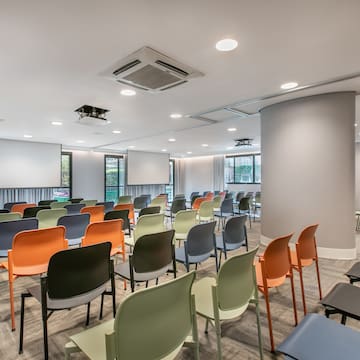 a room with many chairs and tables