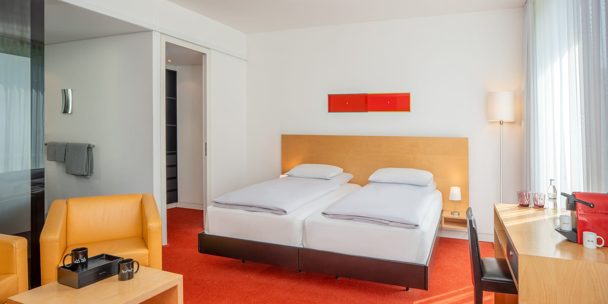 a room with two beds and a desk