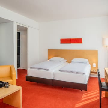 a room with two beds and a desk