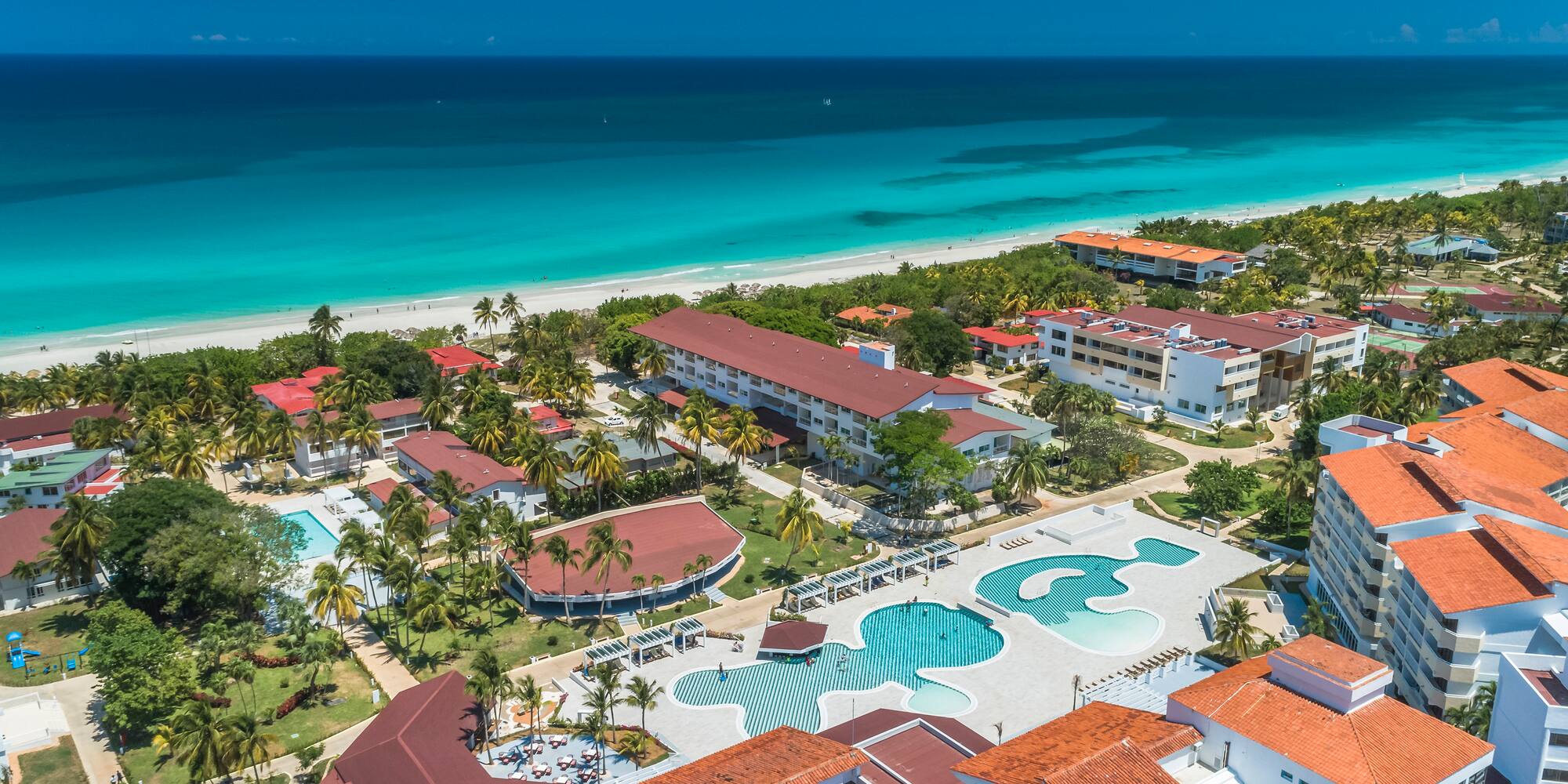 a group of buildings next to a beach