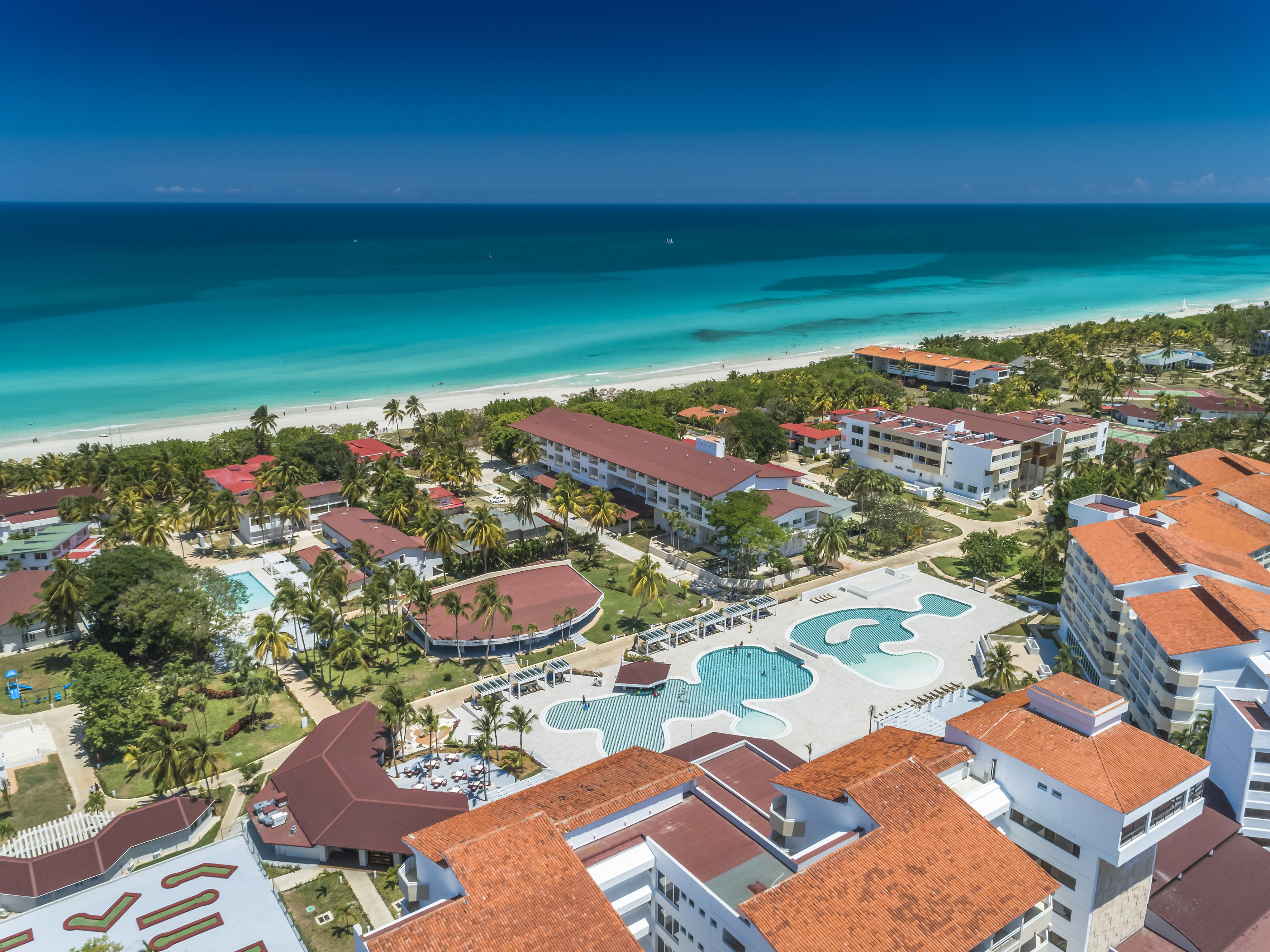a group of buildings next to a beach