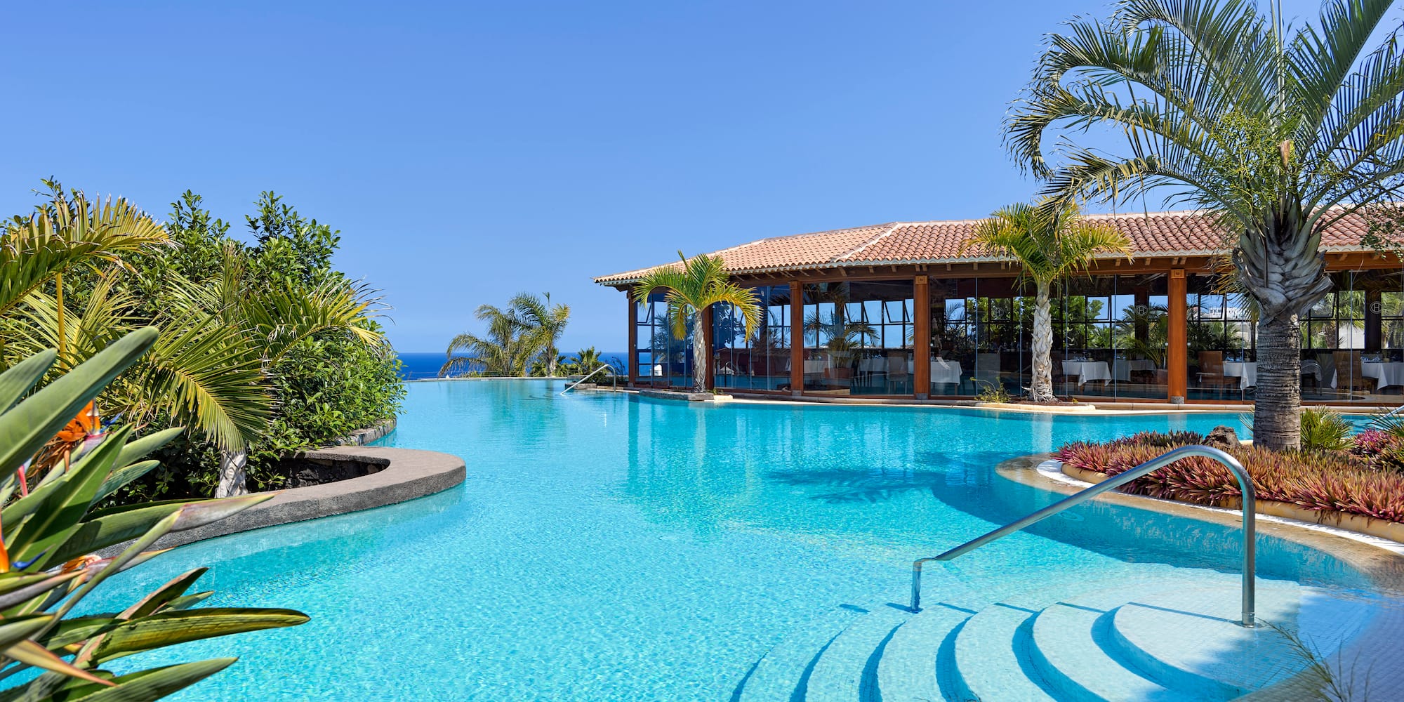 a swimming pool with a gazebo and a building