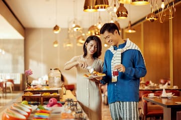 a man and woman standing in a restaurant