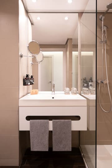 a bathroom with a shower and a sink