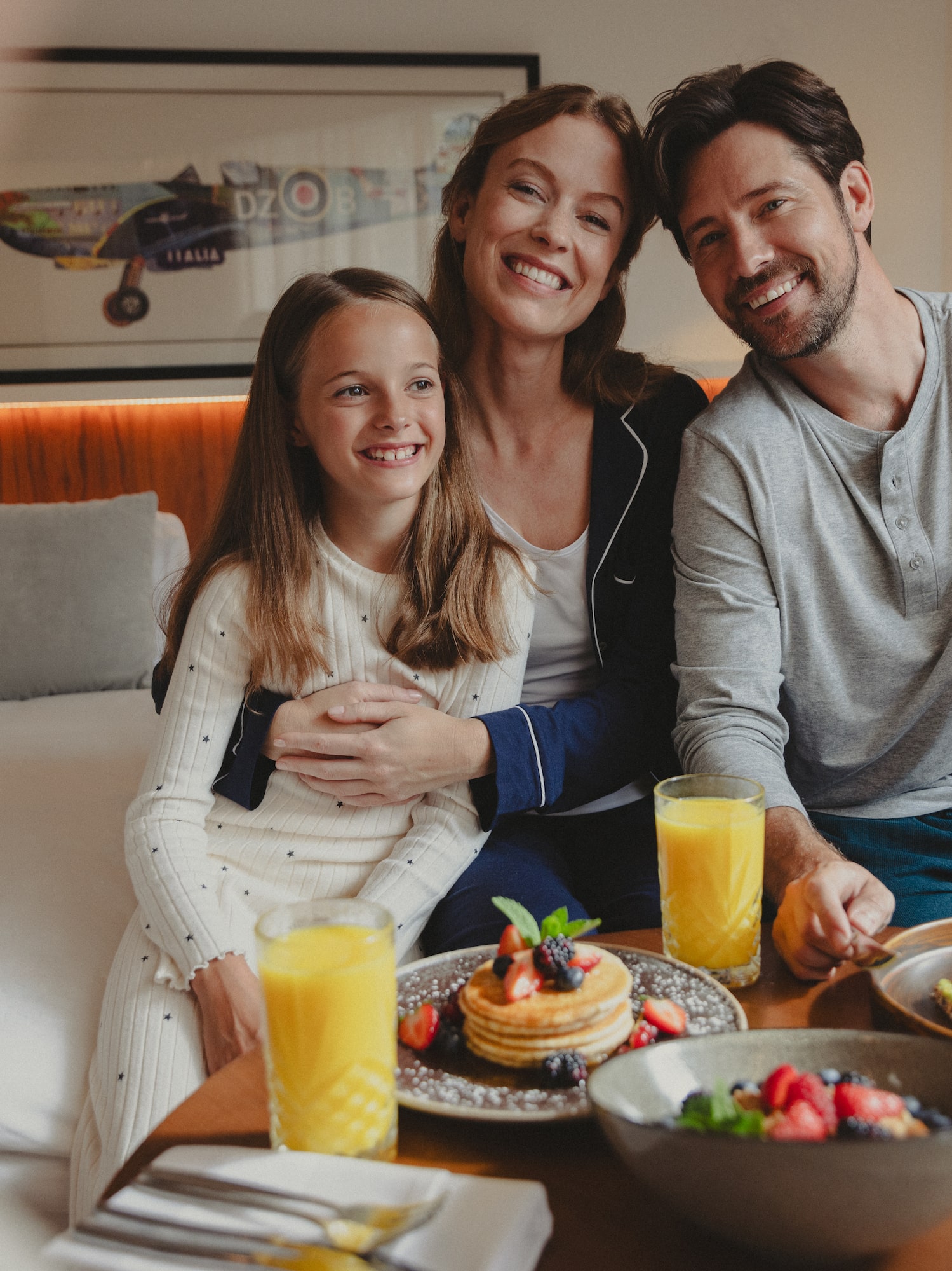 a family sitting at a table with food