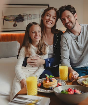 a family sitting at a table with food