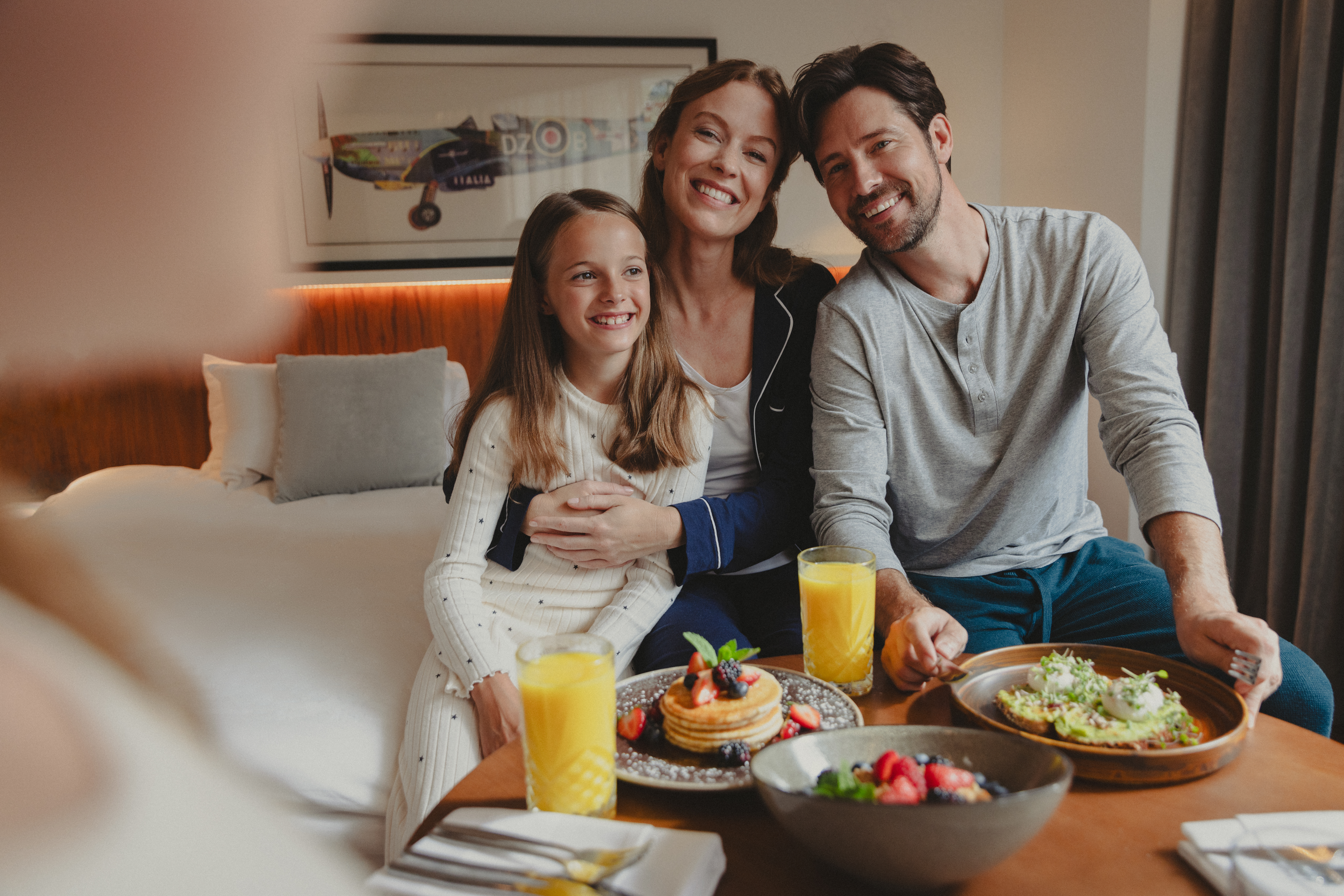 a family sitting at a table with food