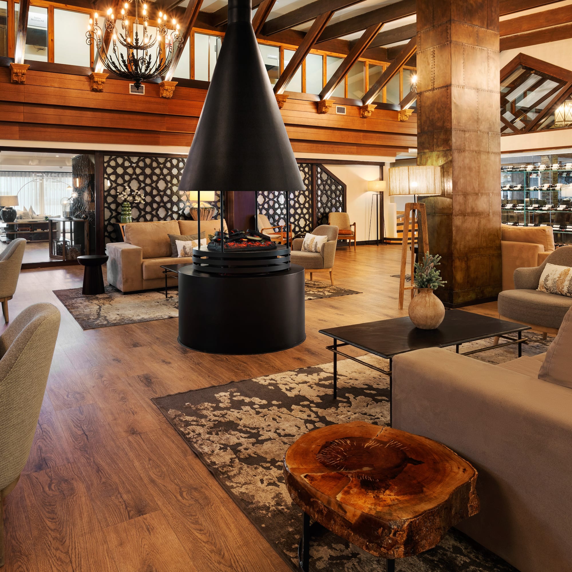 Luxurious hotel lobby with modern fireplace, lounge seating, and wood accents.