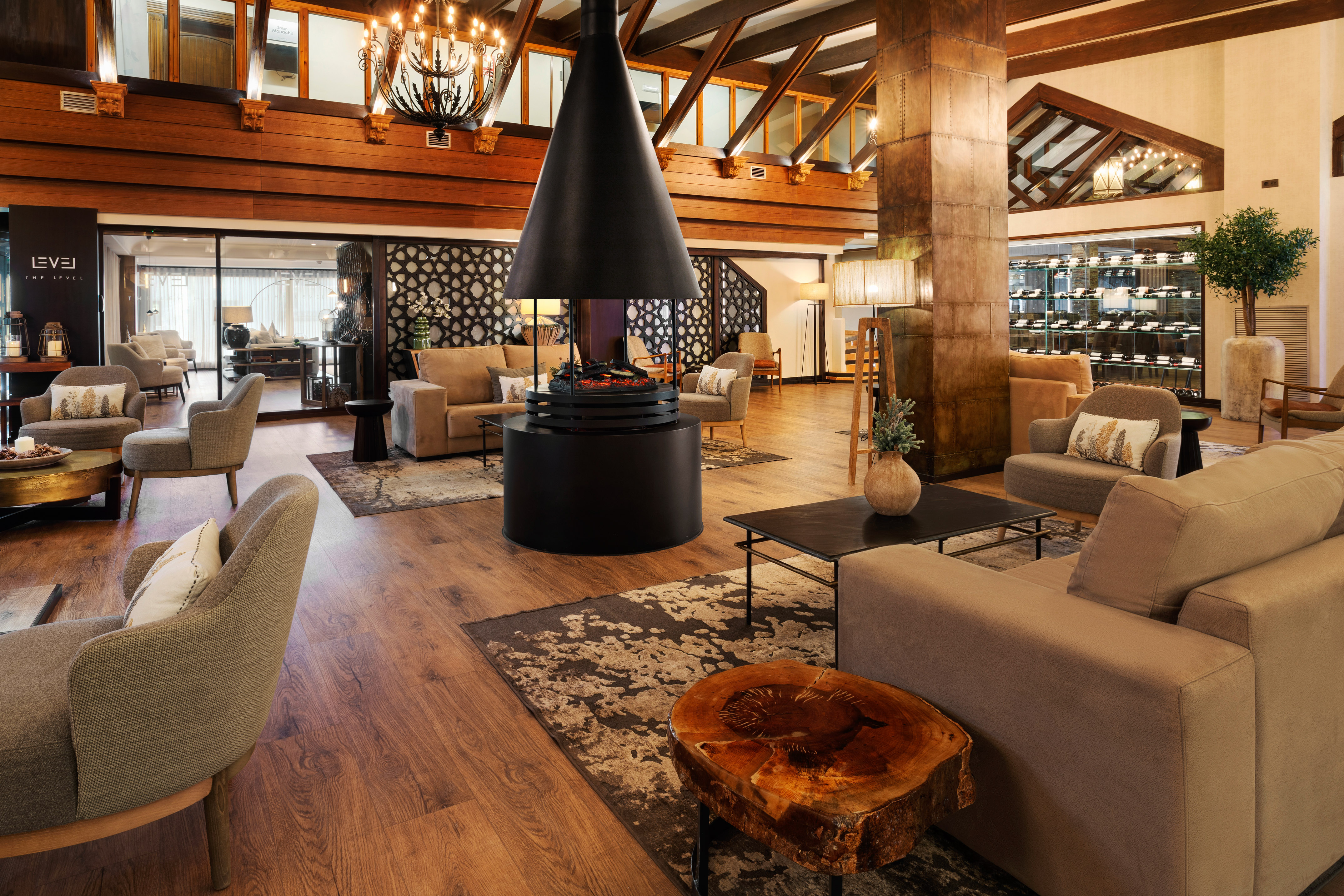 Luxurious hotel lobby with modern fireplace, lounge seating, and wood accents.