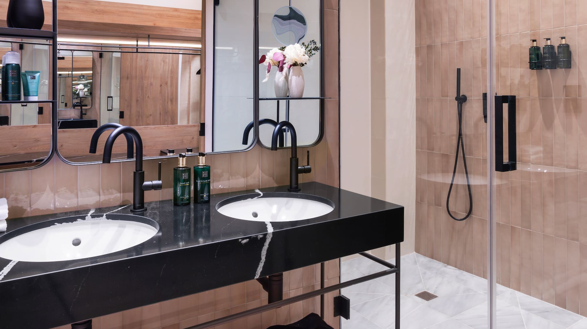 a bathroom with a shower and two sinks