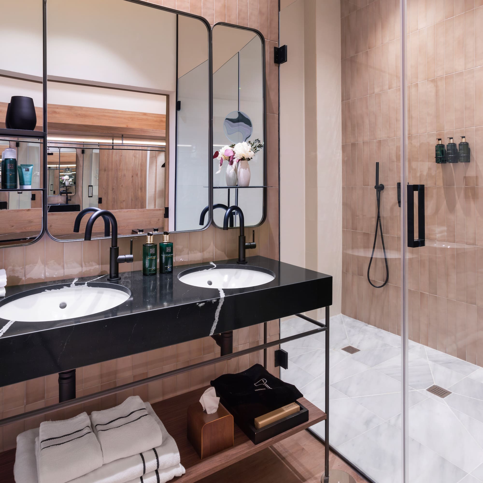 a bathroom with a shower and two sinks