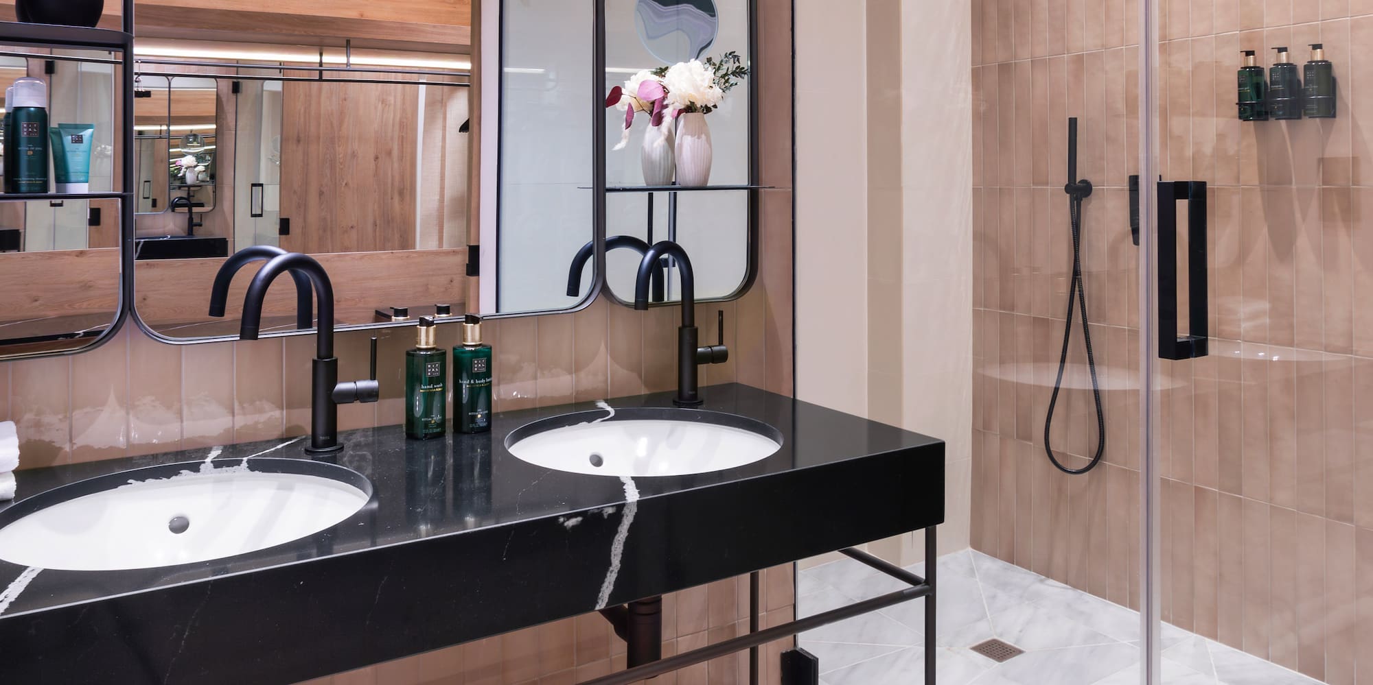 a bathroom with a shower and two sinks