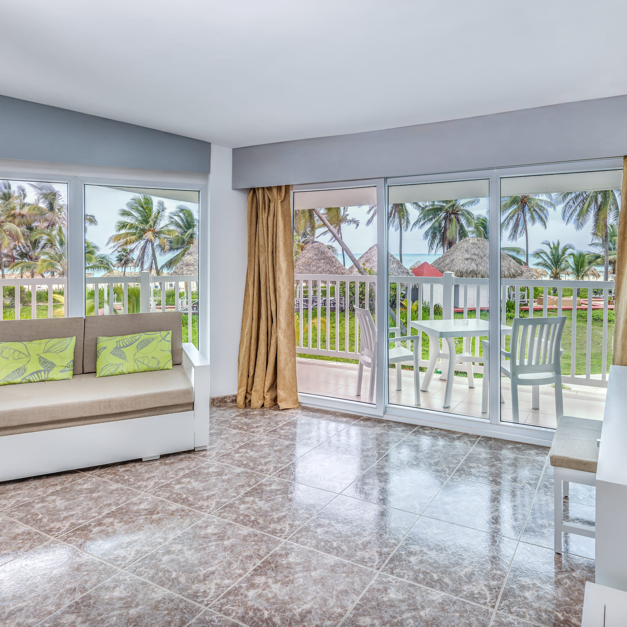 a room with a couch and a table and chairs