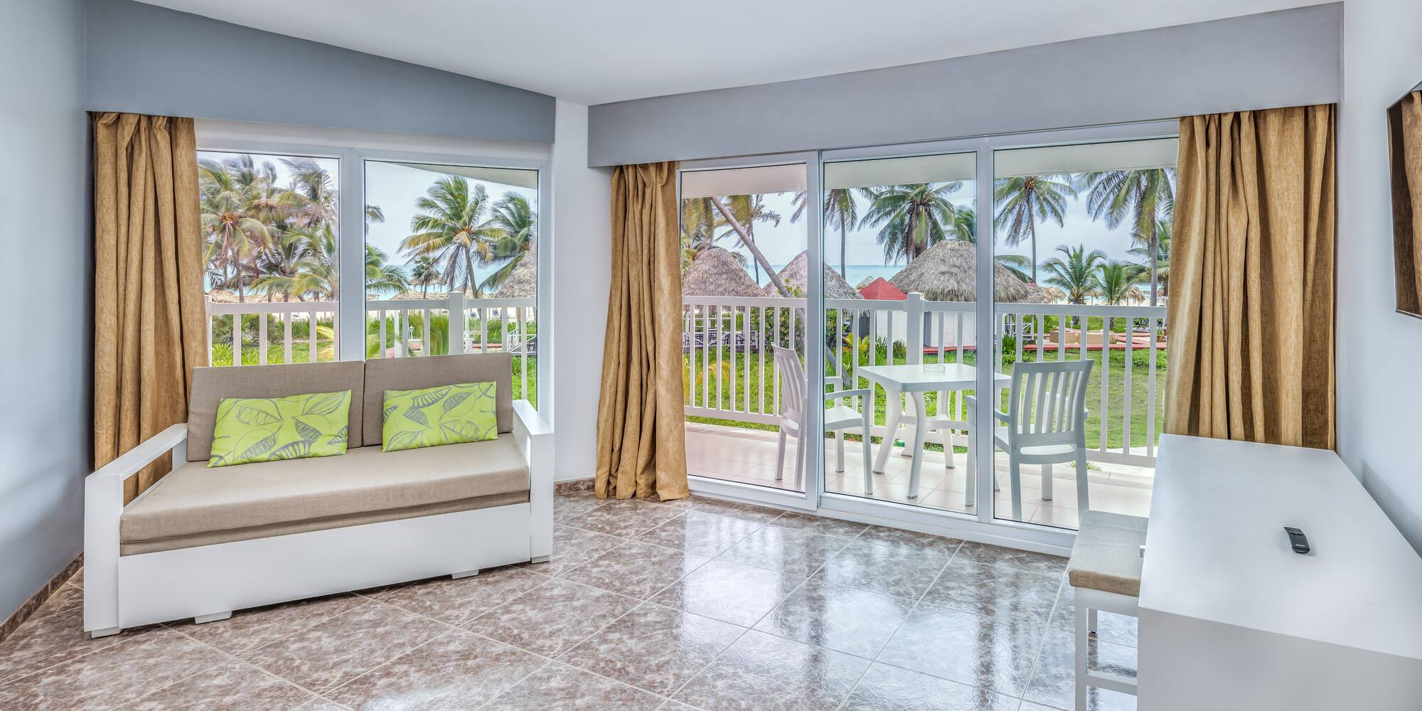 a room with a couch and a table and chairs