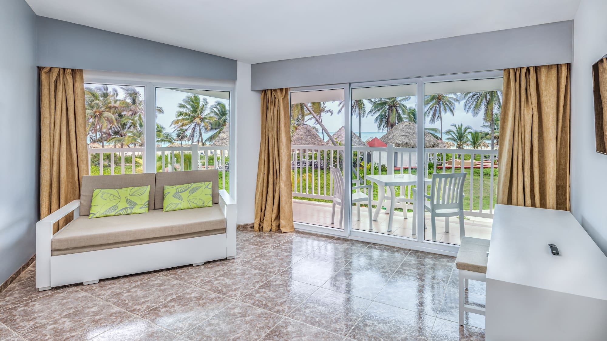 a room with a couch and a table and chairs