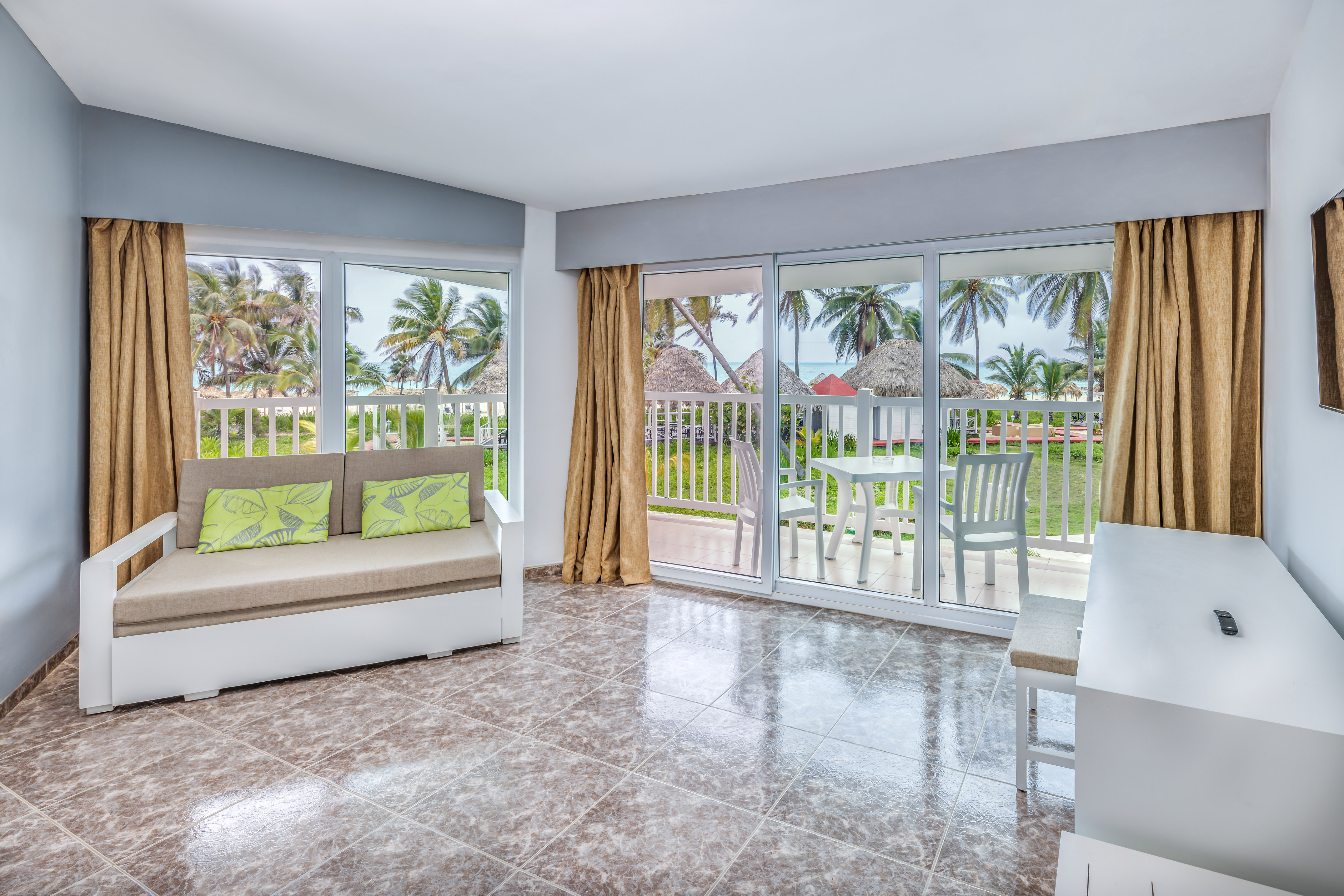 a room with a couch and a table and chairs
