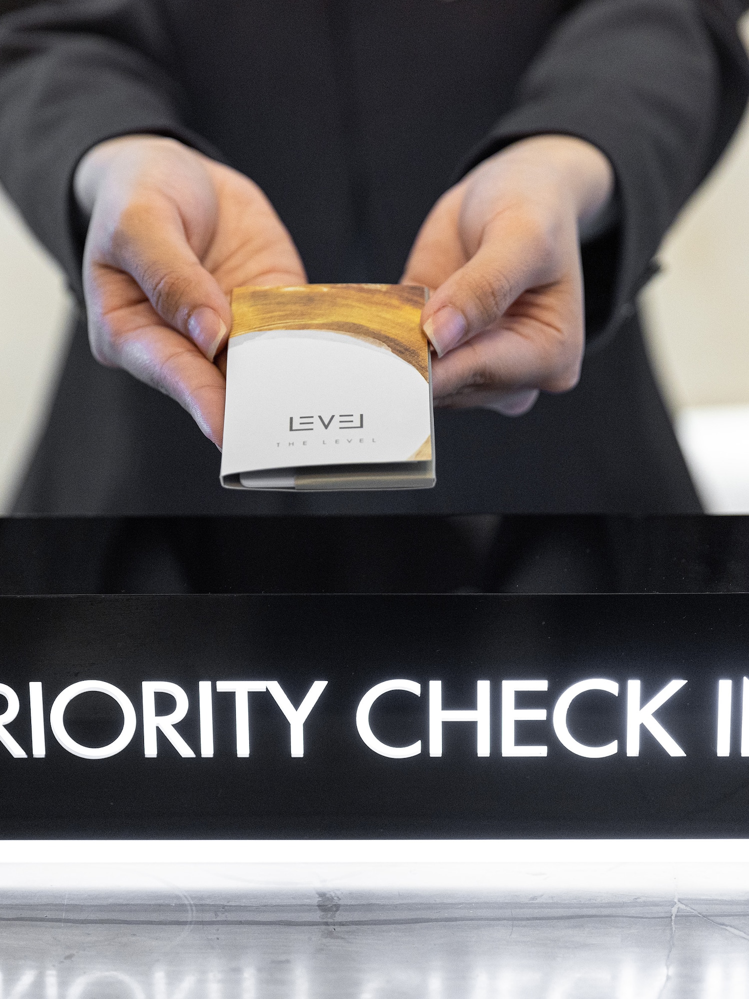 a person holding a box over a sign