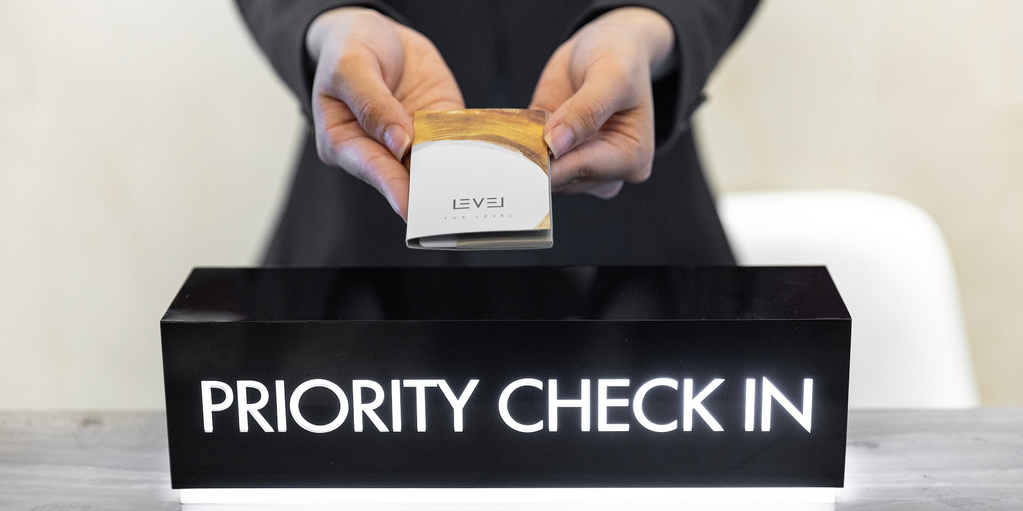 a person holding a box over a sign