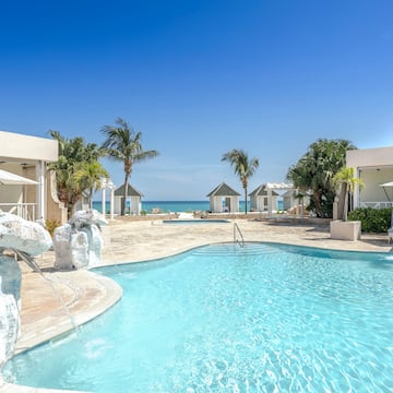 a swimming pool with a fountain and palm trees